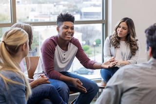 A male shares in a discussion group.