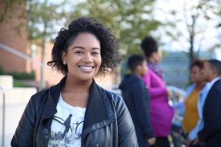 Coppin State student on campus with a group of students in the background